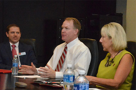 Shawn Eichorst (center) worked with Donde Plowman (right) to create partnerships between athletics and business to build student opportunities.
