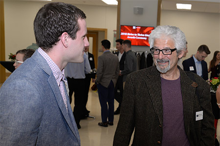 Timothy Wright, a student in the Strive to Thrive Lincoln class project, speaks with Clayton Naff, executive director of Lincoln Literacy, at the awards ceremony reception.