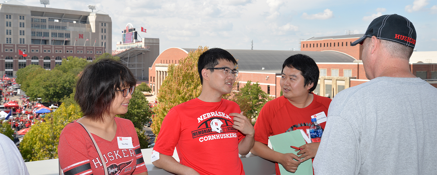 Actuarial Science program guests hang out on the Dean's Terrace before the Husker football contest.