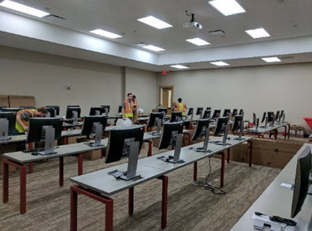 IT workers install new computers in the new classrooms.