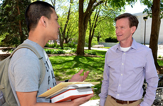 Mark Pogue (right) speaks with Clifton Builder student Phat Nguyen about his future plans on the Nebraska campus. 