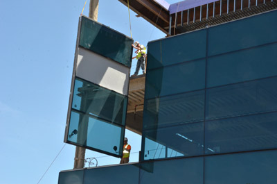 Hausmann workers hang windows at building site