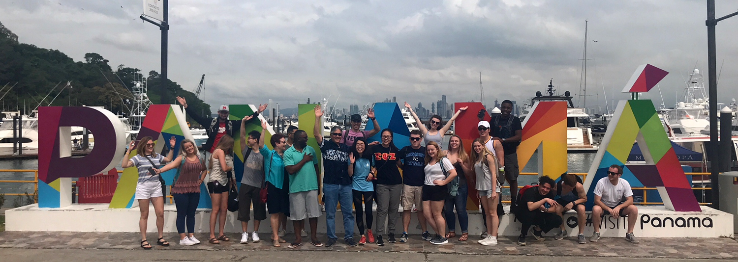 Group in front of Panama sign.