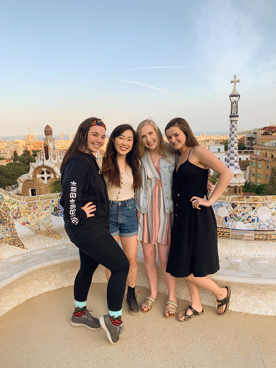 Four students posing in front of the Barcelona skyline.