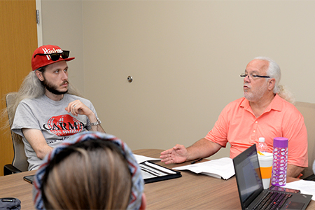 Andrew Hanna consults with Dr. Larry Williams (right) and other Ph.D. students.