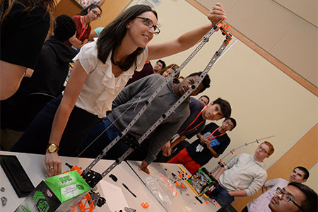 Dr. Christina Carnes, assistant professor of management, determines a winner in the tallest free-standing structure team competition.
