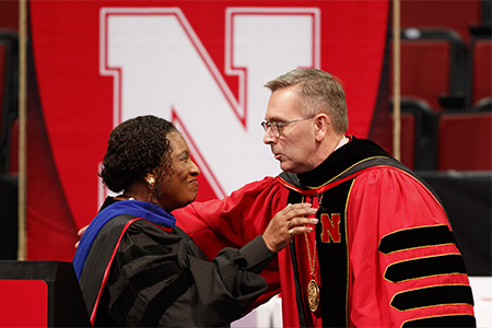 Chancellor Ronnie Green embraces Combs following her speech at commencement. 