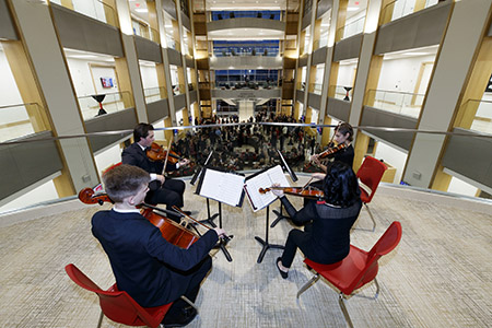 The Amore String Quartet perform for guests in the Henrickson Family Atrium.