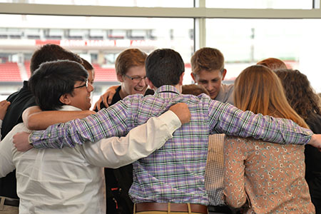High school students huddle up before the competition begins.