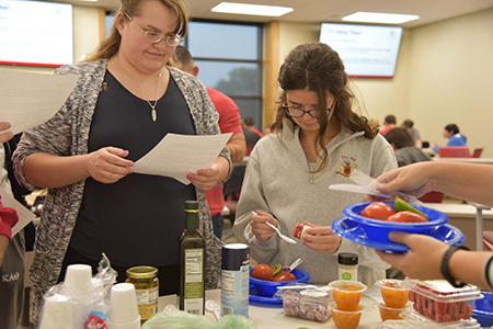 Students could select from a table full of ingredients, some of which included peaches, peppers and seasonings.