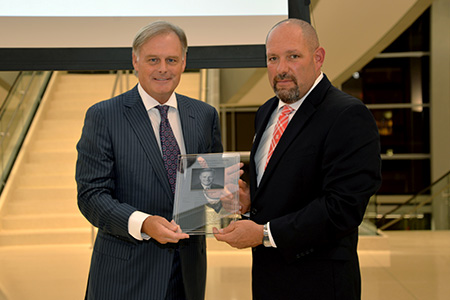 Tonn Ostergard (left) receives award from Dr. Aaron Crabtree