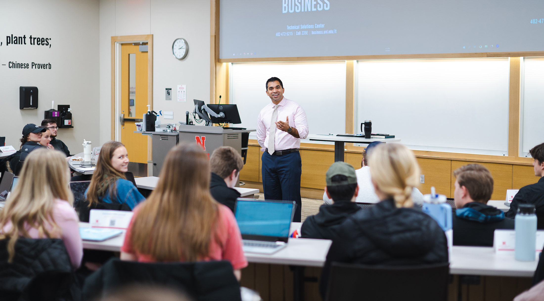 A student raising his hand in a class.