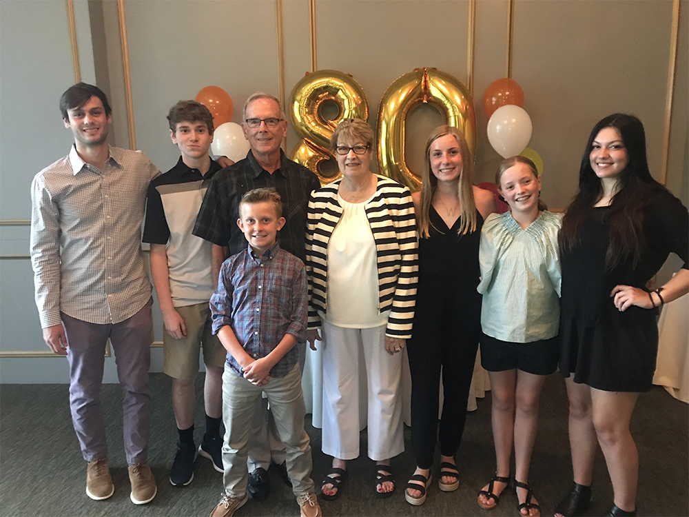 Dick celebrating Helen’s 80th birthday with their grandchildren.