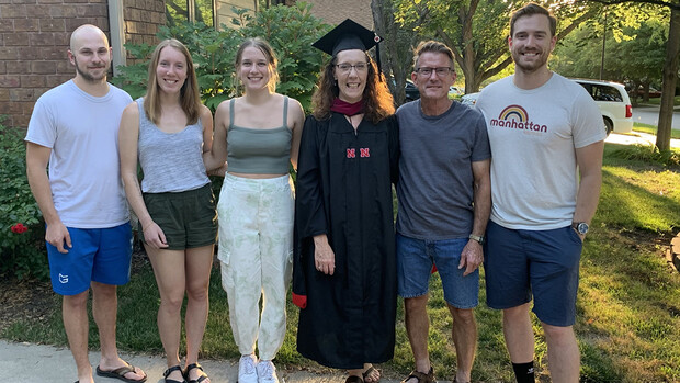 Mikki Sandin stands with her family after earning a degree.