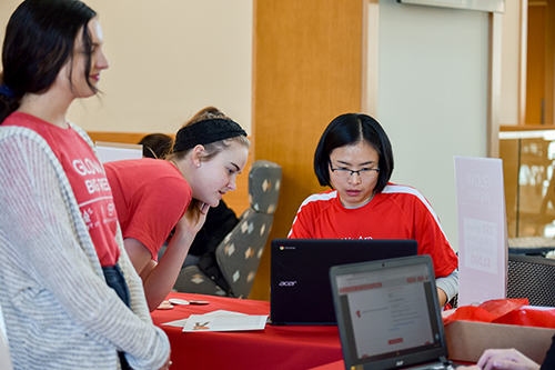 Liying Wang, assistant professor of finance, makes her donation at last year's Glow Big Red college kickoff event.