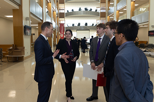 Vala talks with the Kansas State University team that earned second place after the competition..