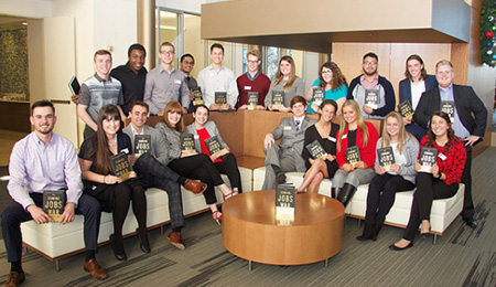 Students pose with copies of Jim Clifton's book The Coming Jobs War.