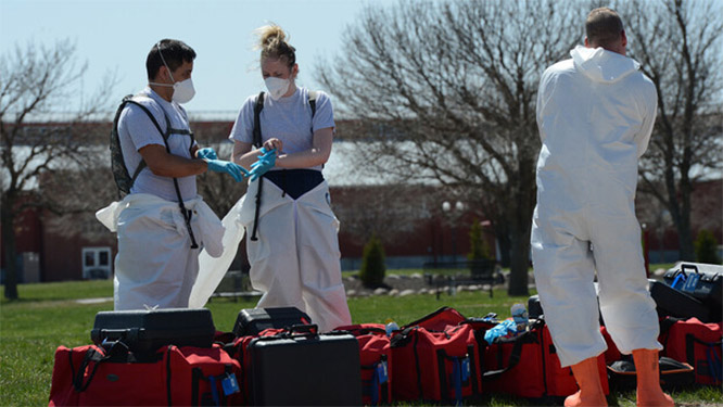 Members of the 155th Medical Group follow health safety protocols by wearing personal protective equipment while preparing to open a testing station in Grand Island on April 7.