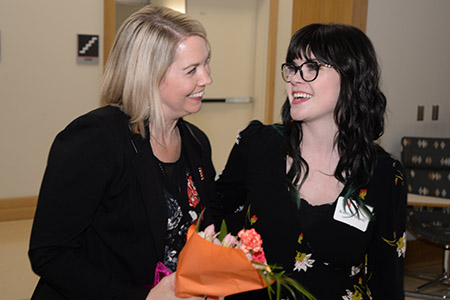 Dr. Amber Messersmith is presented flowers by Kaitlyn Hundt, representing all of the Strive to Thrive class members.