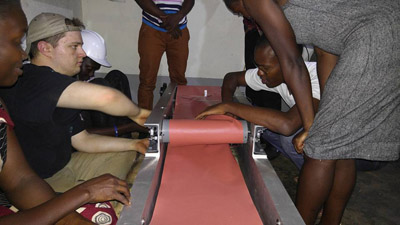 UNL and Uganda students set up straw flattening machine