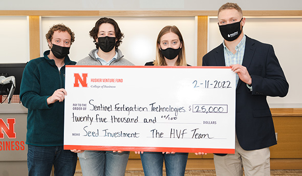 Students and managing directors of the fund – Keith Nordling, Adam Folsom, and Emily Kist – alongside Stansell holding the $25,000 check awarded to his startup, Sentinel Fertigation.