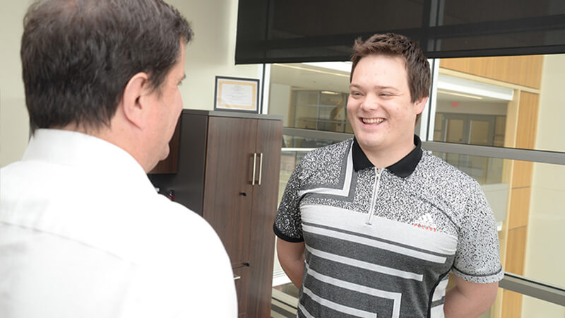 Student talking to faculty member