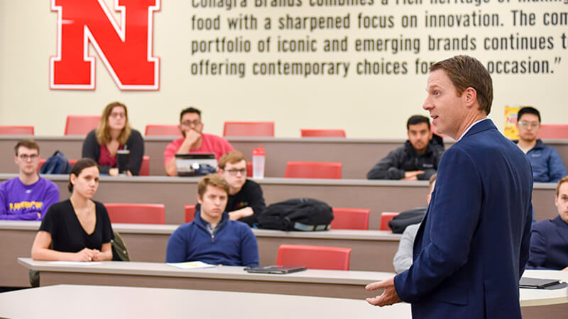 Students listening to professor in classroom.