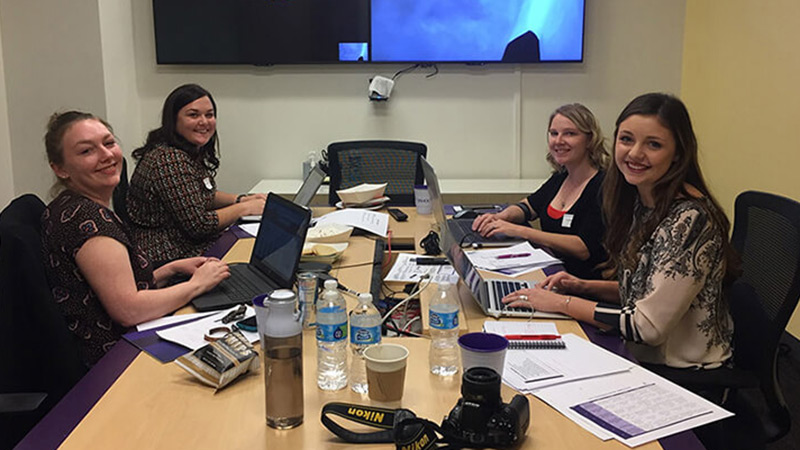 Students around table present a case on Yahoo.
