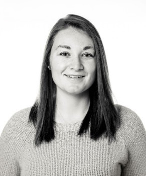 Summer Horowitz; Woman with shoulder-length dark hair wearing a knitted sweater, face blurred, in black and white.