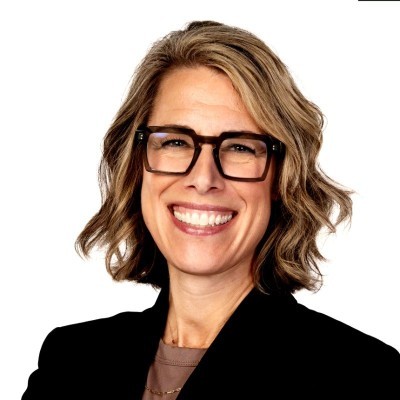 Morgan Shaw Parker; Businesswoman with wavy, shoulder-length hair wearing a black blazer against a white background.
