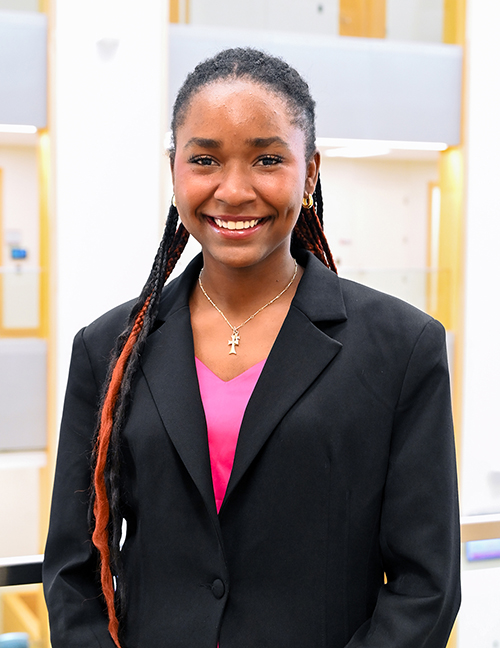 Alexandra Konmegne standing in the Atrium in Hawks Hall