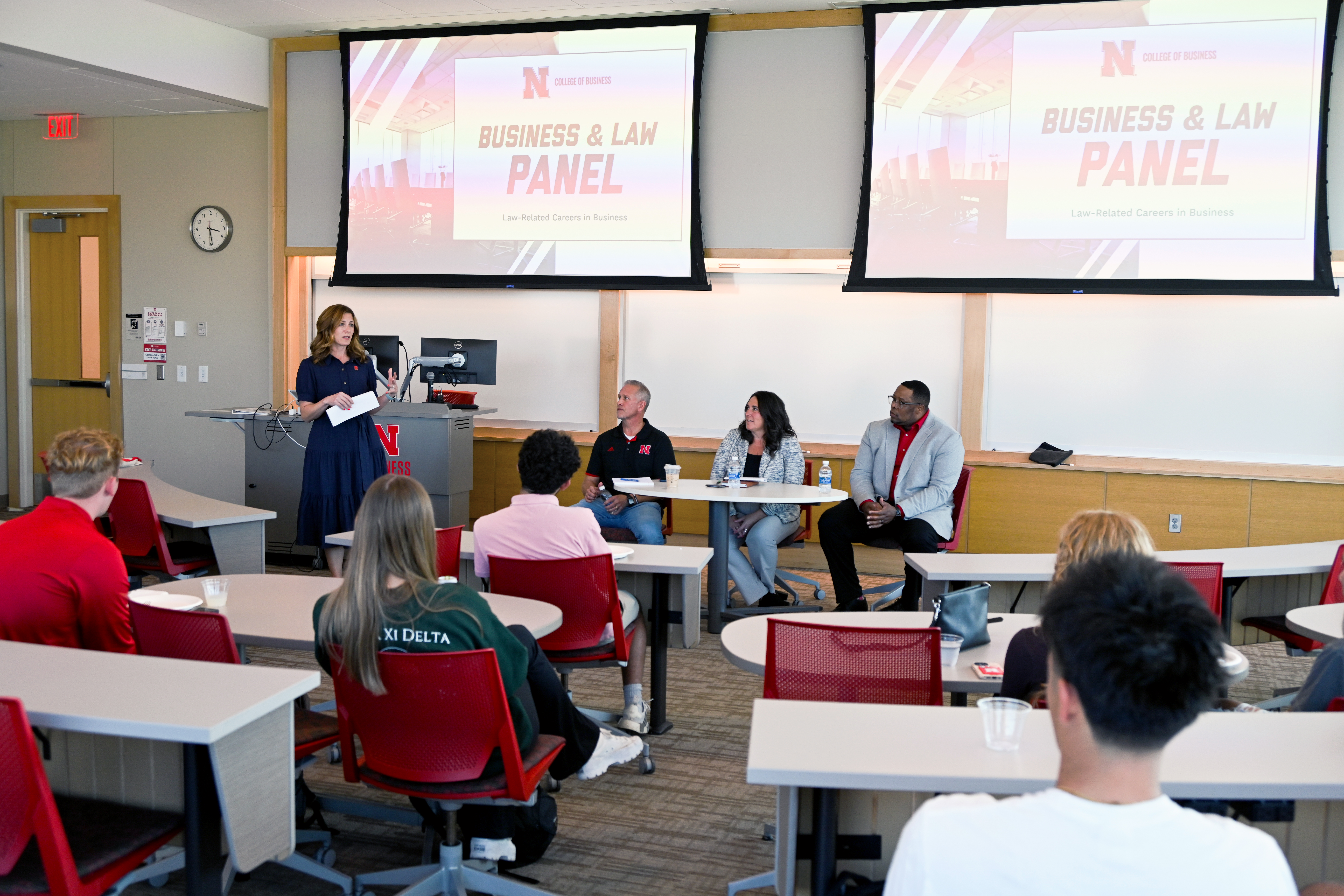 Business and Law panel at a university, speaker addressing audience seated in a classroom.