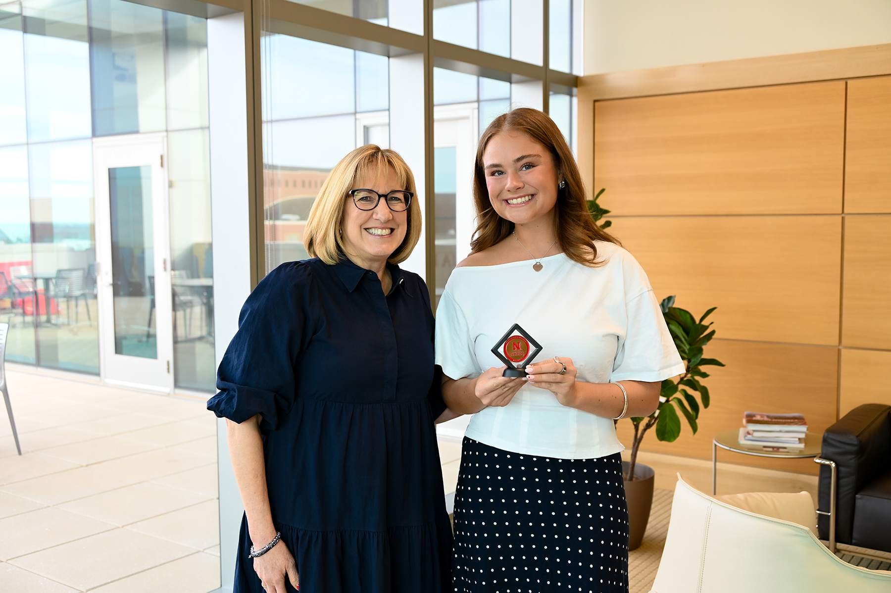 Delany Huck receiving the student of the month award from Kathy Farrell