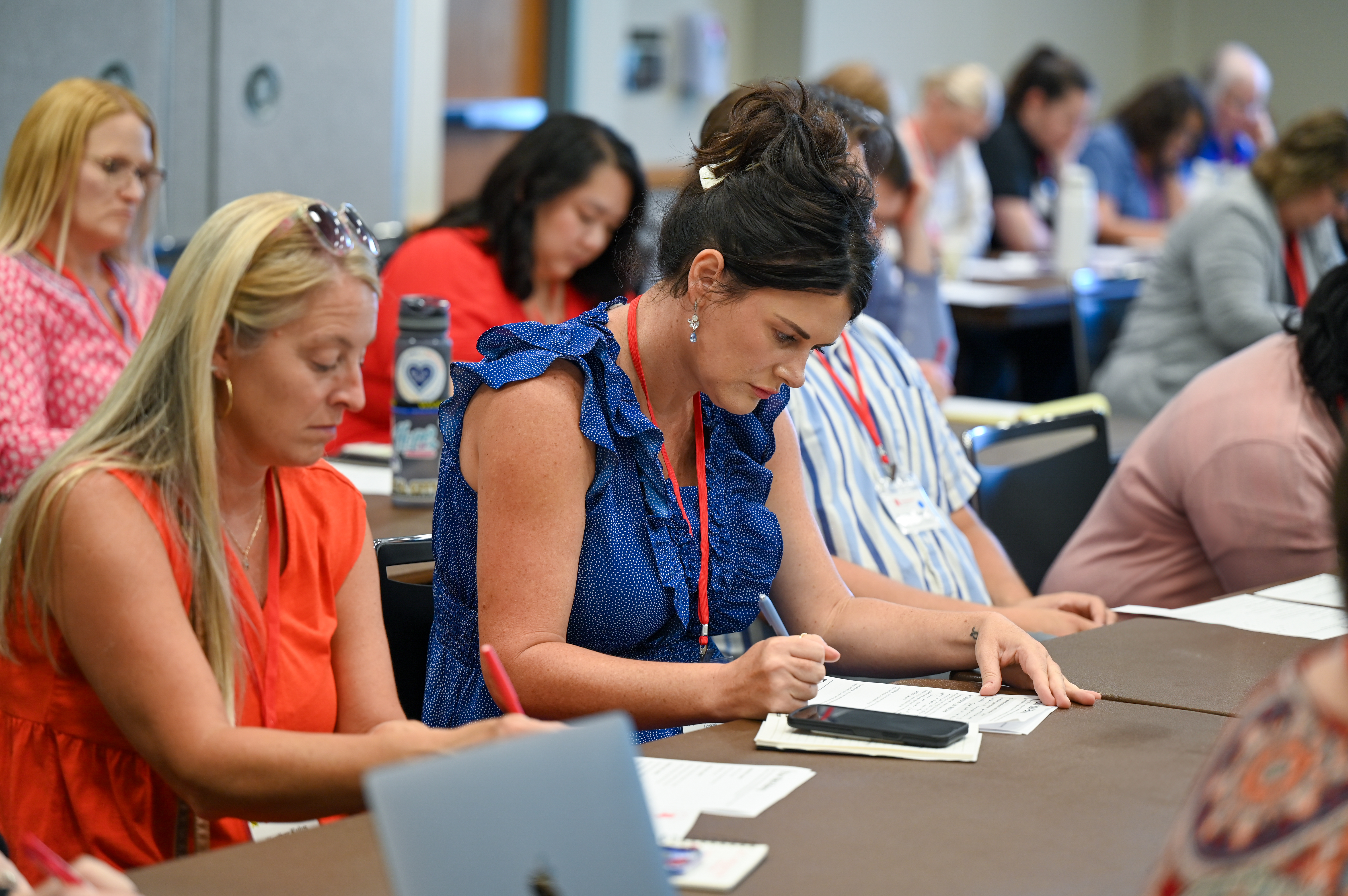 Attendees at the Clifton Strengths Conference completing a worksheet.
