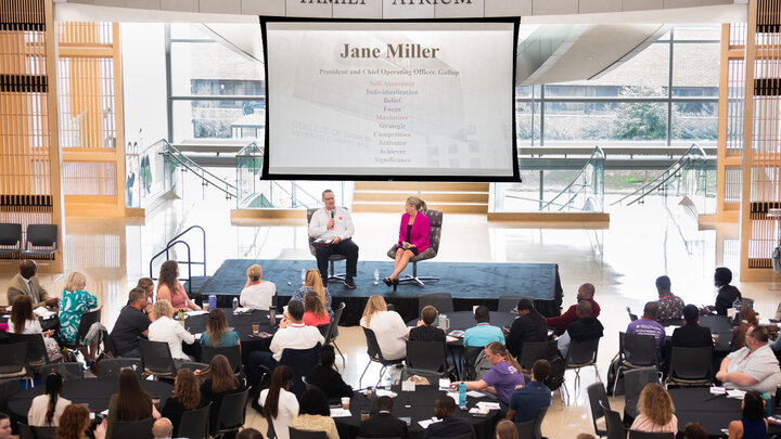 Tim Hodges interviewing Jane Miller on stage.