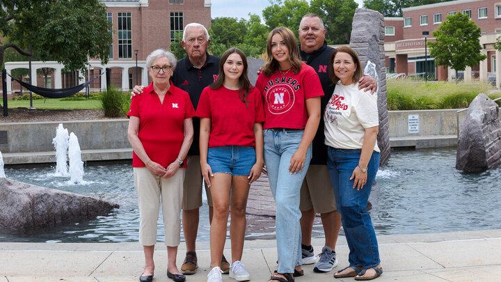 Lauren (third from left) and Madison (third from right) pose for a family photograph on campus with their grandparents and parents.