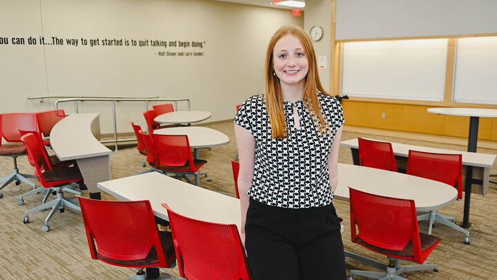 Hannah LaMaster standing in a classroom in Hawks Hall