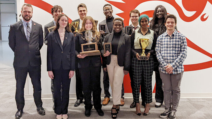 The national champion debate team includes (front row, from left) Juliana Quattrocchi, Amber Tanehill, Andromede Uwase, Azza Elhaj, assistant coach Colin Dike, (back row, from left) director Justin Kirk, Zachary Wallenburg, Nick Wallenburg, Salman Djingueinabaye, Gregory Quick and Omaima Lado.