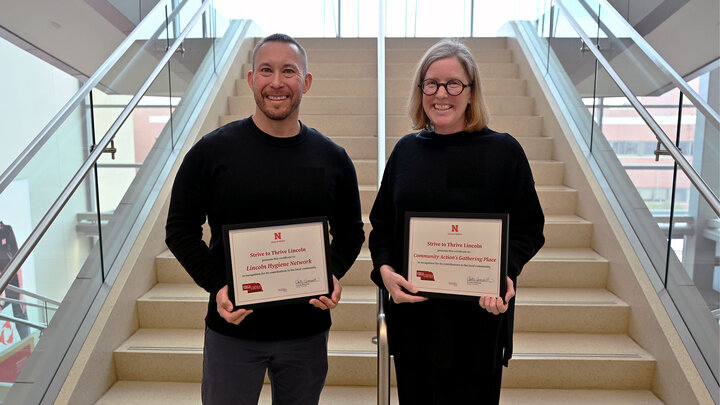 Dustin Oltman and Lisa Janssen accept Strive to Thrive Lincoln grants on behalf of their nonprofits.