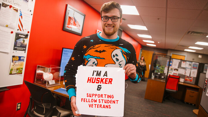 Kyle Potratz standing with I'm a Husker Plaquette