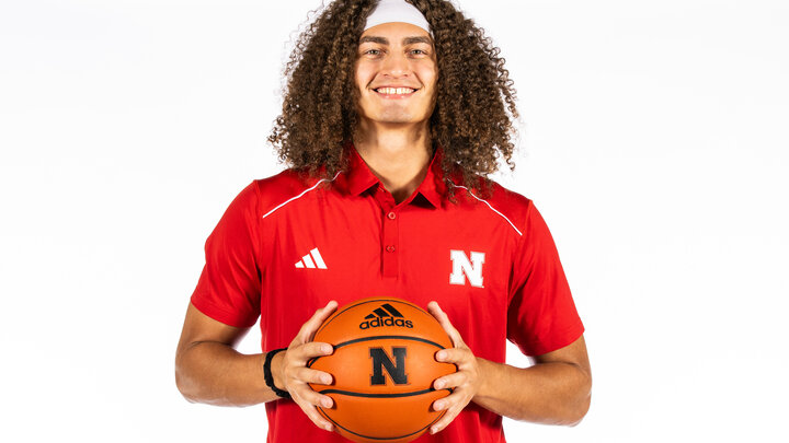 Josiah Allick holding a basketball from when he was a Husker graduate assistant.