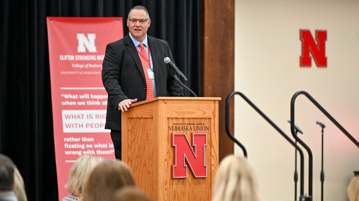 Timothy Hodges, Clifton Strengths Institute, greets attendees at podium