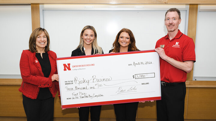 Juniors Valerie Bohuslavsky and Jordan Kuhn captured first place in the Center for Sales Excellence Team Role-Play Competition sponsored by Balto and received their check from Dean Kathy Farrell and Blake Runnalls, assistant professor of marketing.