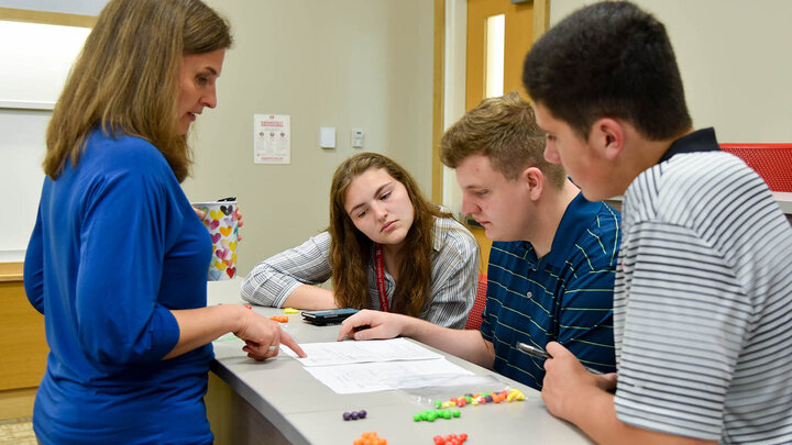 Seth Sherwood (center) works with other students and Jill Trucke, assistant professor of practice in accountancy, on an inventory project.