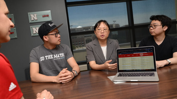 Dr. Yijia Lin, N.Z. Snell Life Insurance Professor, discusses research with Sue Vagts, director of the Actuarial Science Program and Ameritas Faculty Fellow, and graduate students.