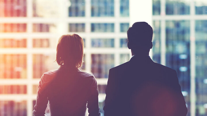 Businesspeople looking out window