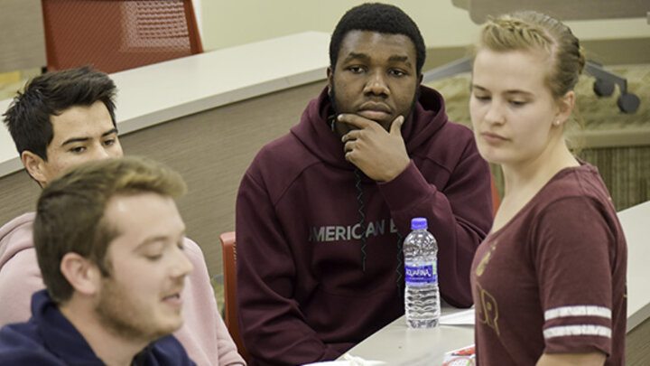 Quincey Bernard (center) working with his team at the Innovation Challenge, an entrepreneurial event hosted at the College of Business.