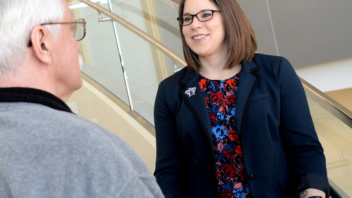 Abby Nappier Cherup talks with advisor Dr. Les Carlson who encouraged her marketing research on inclusivity for the bi-plus community.