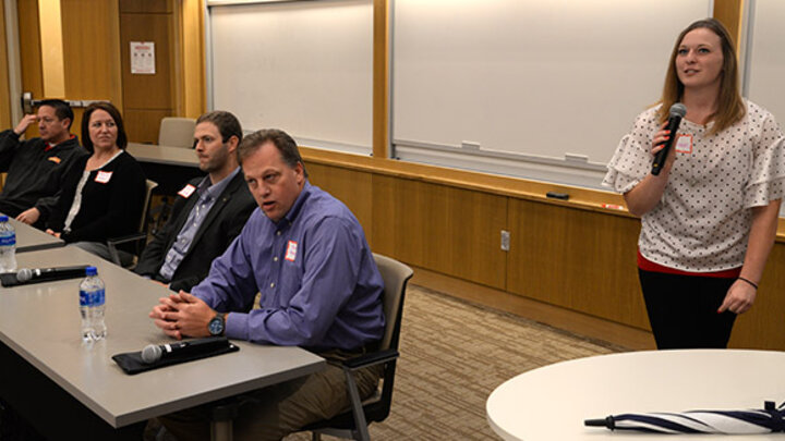 Allison Olmer, president of the Nebraska Supply Chain Club, introduces panelists to the students in attendance.