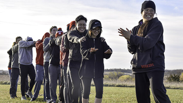 Lynn Diep leads her classmates through a team-building activity at Nebraska’s Outdoor Challenge Course.